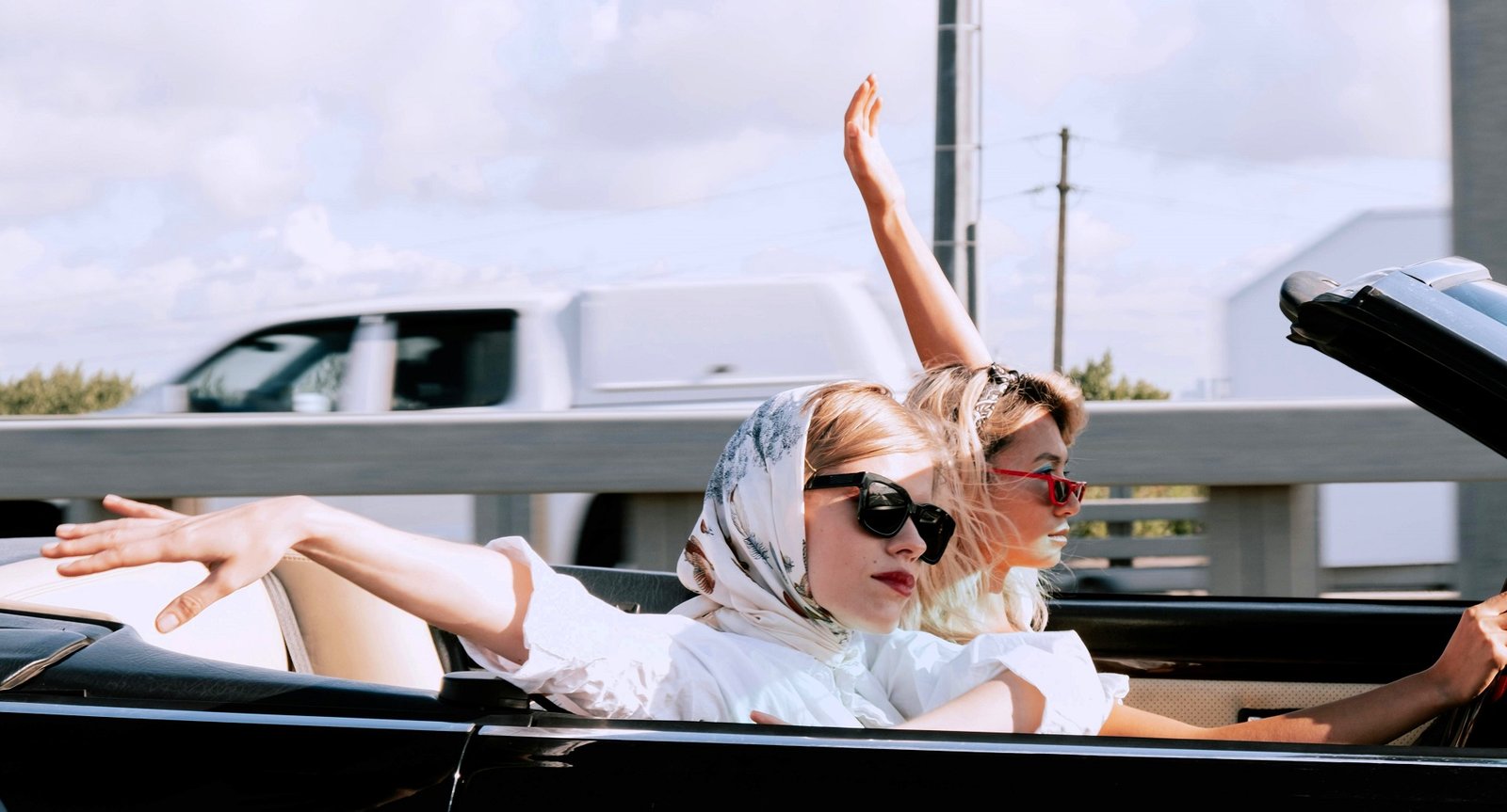 two women in a rental car take a vacation in palm springs